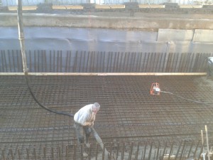 Concrete pumped into basement and vibrated into place