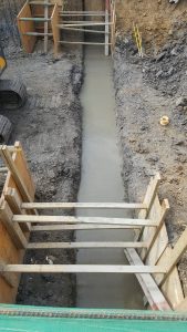 Three ground beams cast with 500mm of concrete and steel run the width of the building, providing support for the houses next door